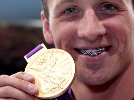 Ryan Lochte is presented with diamond encrusted gold razors by Gillette Ryan Lochte is presented with diamond encrusted gold razors by Gillette
