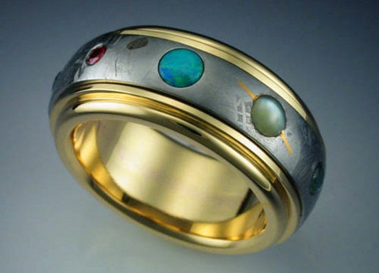 A ring made from meteorite sports gemstones representing planets in the solar system